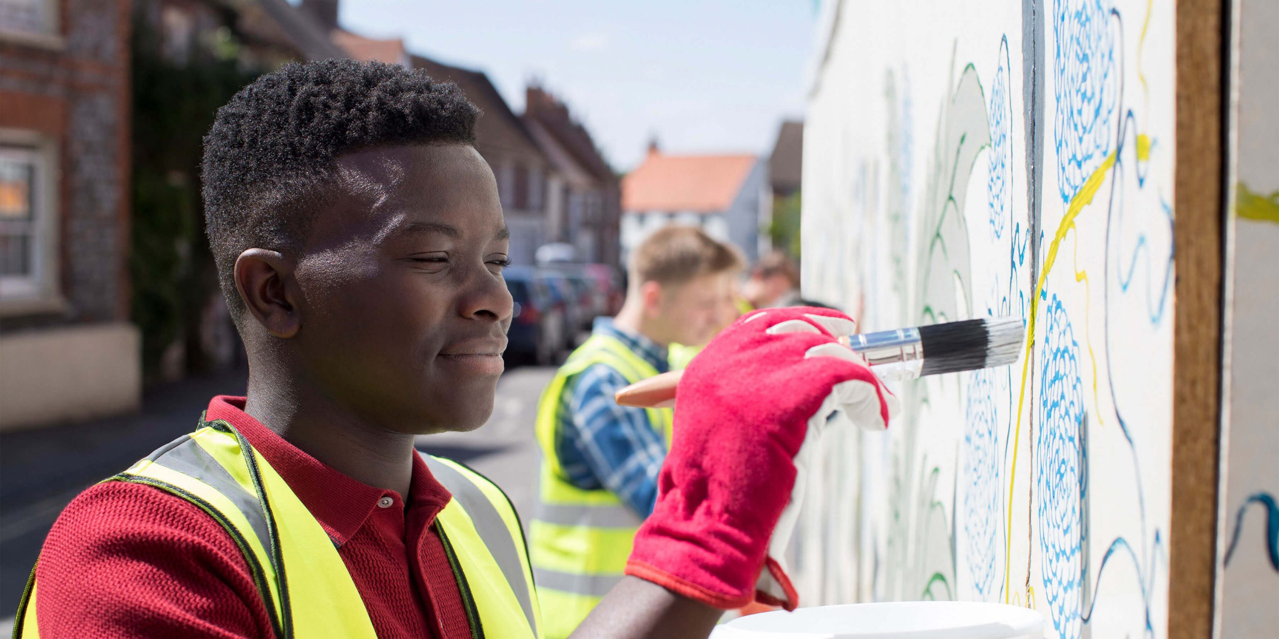 community volunteers painting a wall